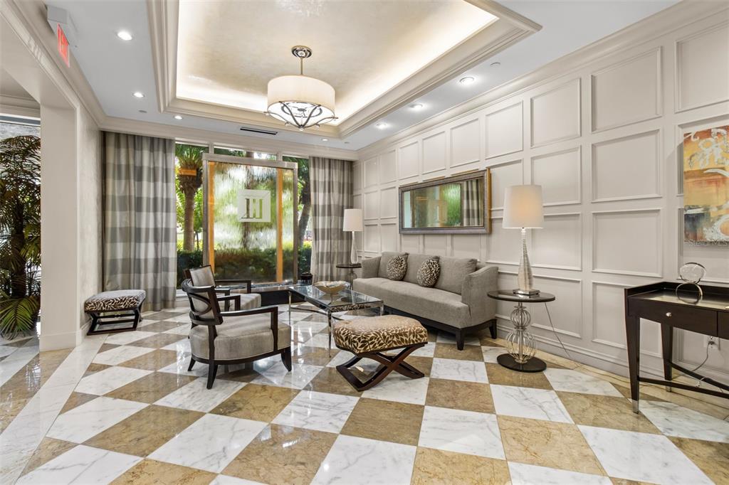 331 Cleveland Street, Unit 2102 Clearwater, FL 33755 - Photo 46 of 66 a living room with furniture a rug and a chandelier