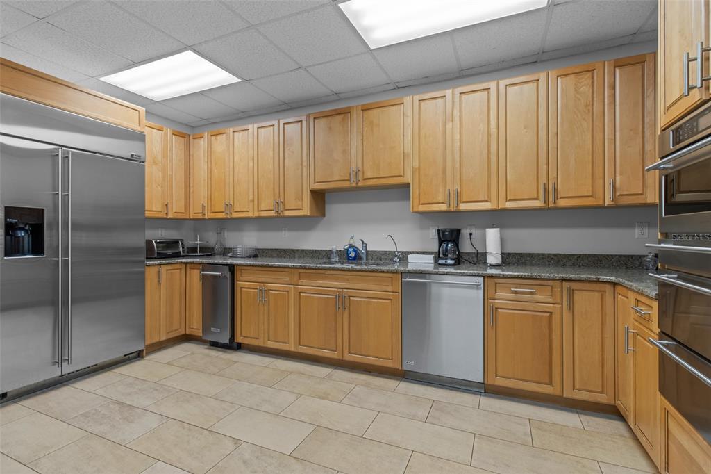 331 Cleveland Street, Unit 2102 Clearwater, FL 33755 - Photo 47 of 66 a kitchen with stainless steel appliances granite countertop a stove a sink and a refrigerator