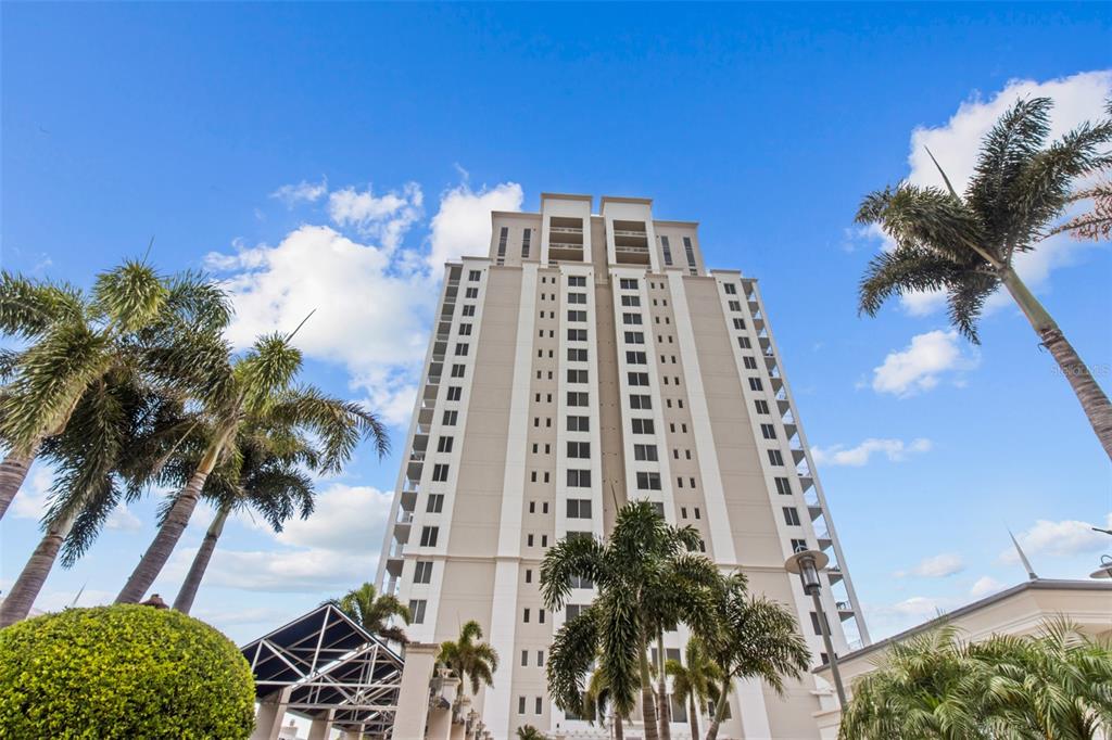 331 Cleveland Street, Unit 2102 Clearwater, FL 33755 - Photo 55 of 66 a front view of multi story residential apartment building with a yard
