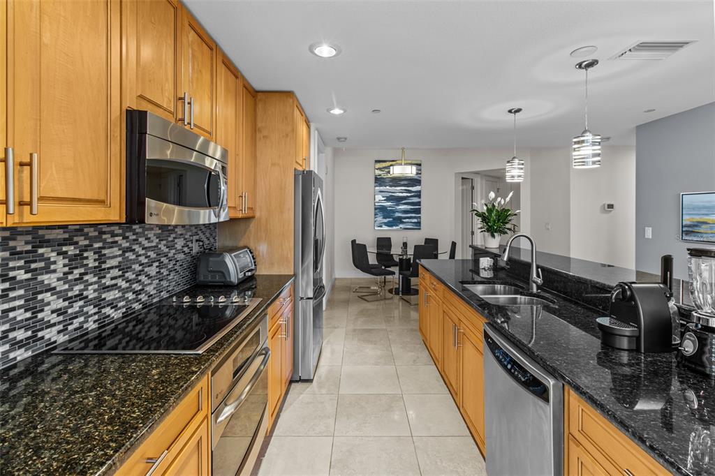 331 Cleveland Street, Unit 2102 Clearwater, FL 33755 - Photo 8 of 66 a kitchen with sink stove and cabinets