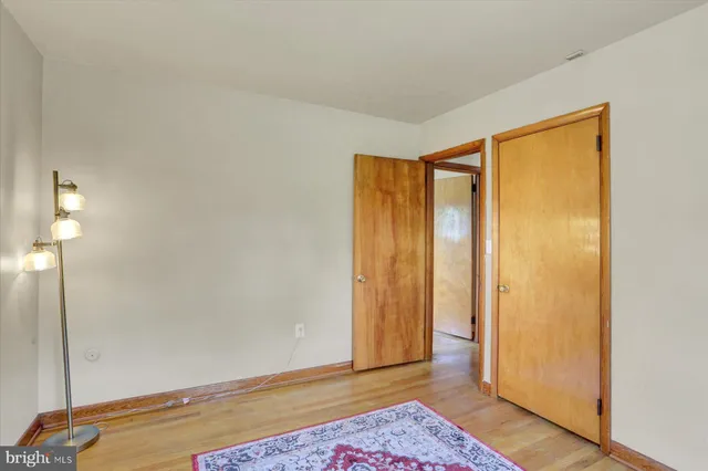 a view of room with window and wooden floor
