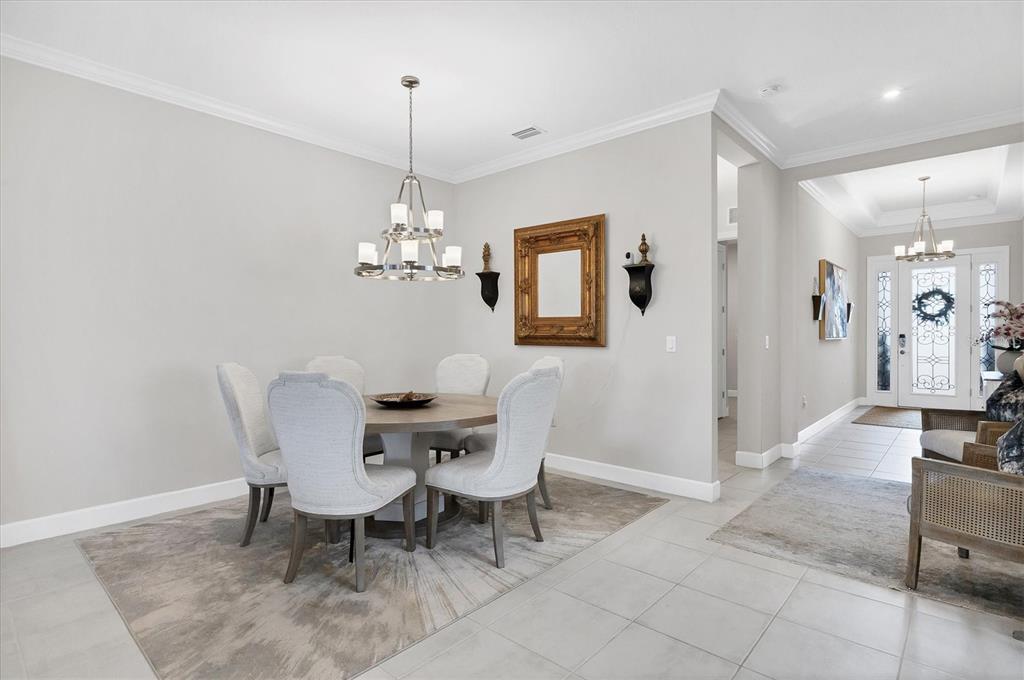 4735 Cassio Court Bradenton, FL 34211 - Photo 14 of 100 a dining room with furniture a chandelier and wooden floor