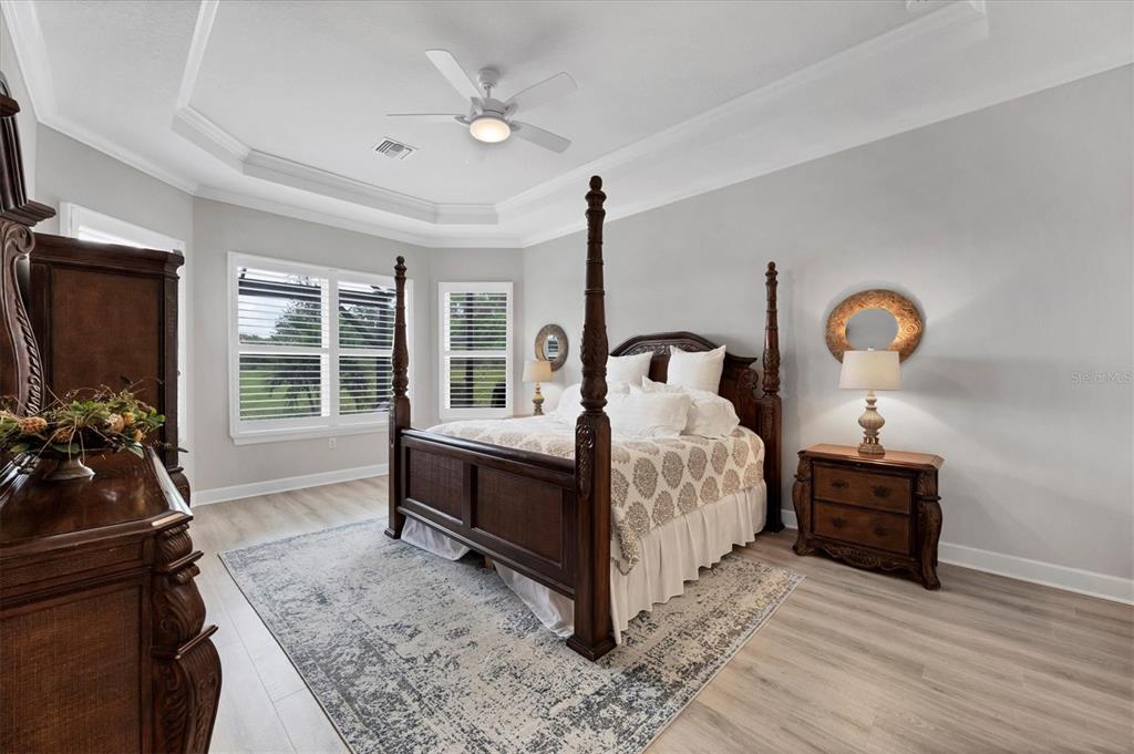 4735 Cassio Court Bradenton, FL 34211 - Photo 16 of 100 a bedroom with a bed and a dresser next to a window