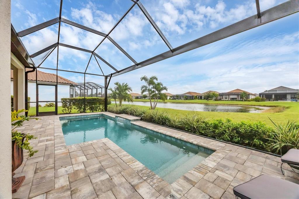 4735 Cassio Court Bradenton, FL 34211 - Photo 2 of 100 a view of a swimming pool with a patio and a yard