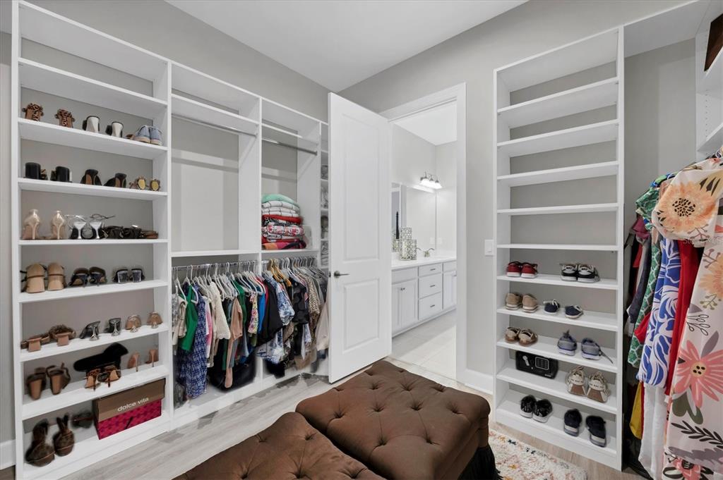 4735 Cassio Court Bradenton, FL 34211 - Photo 21 of 100 a view of walk in closet with clothes and shoes