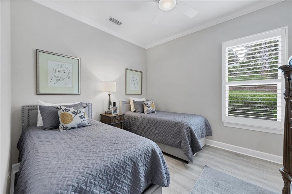 4735 Cassio Court Bradenton, FL 34211 - Photo 22 of 100 a bedroom with two beds and a window