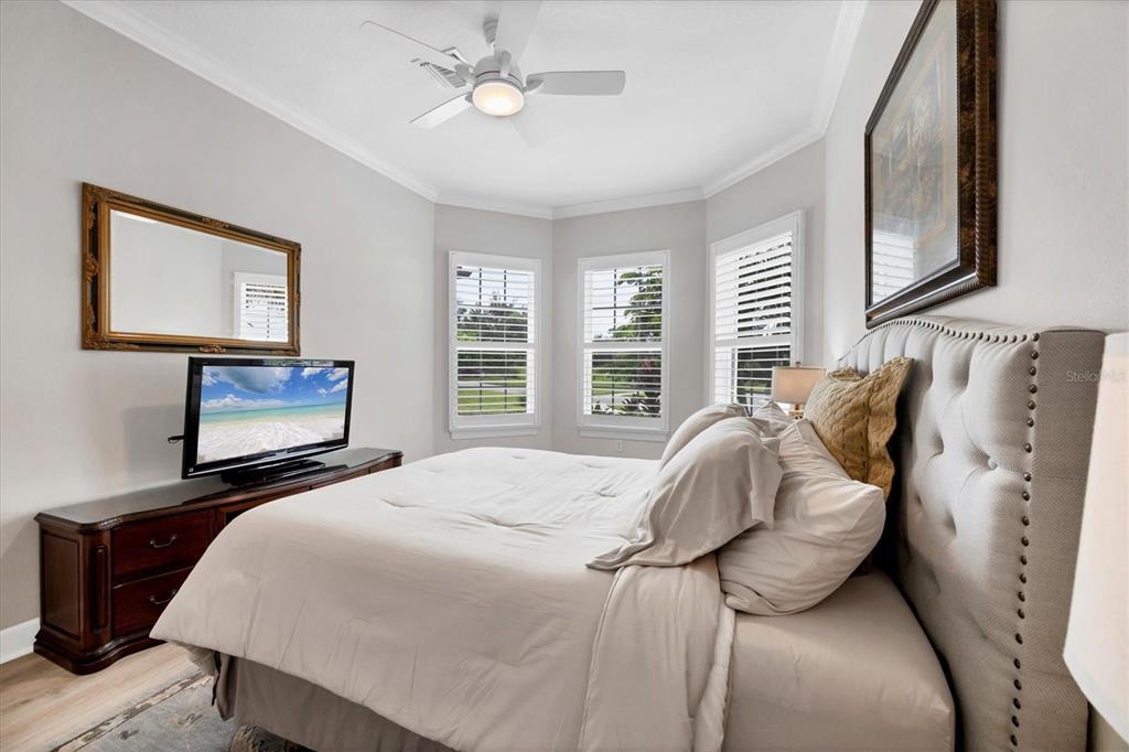 4735 Cassio Court Bradenton, FL 34211 - Photo 26 of 100 a bedroom with a bed and a painting on the wall