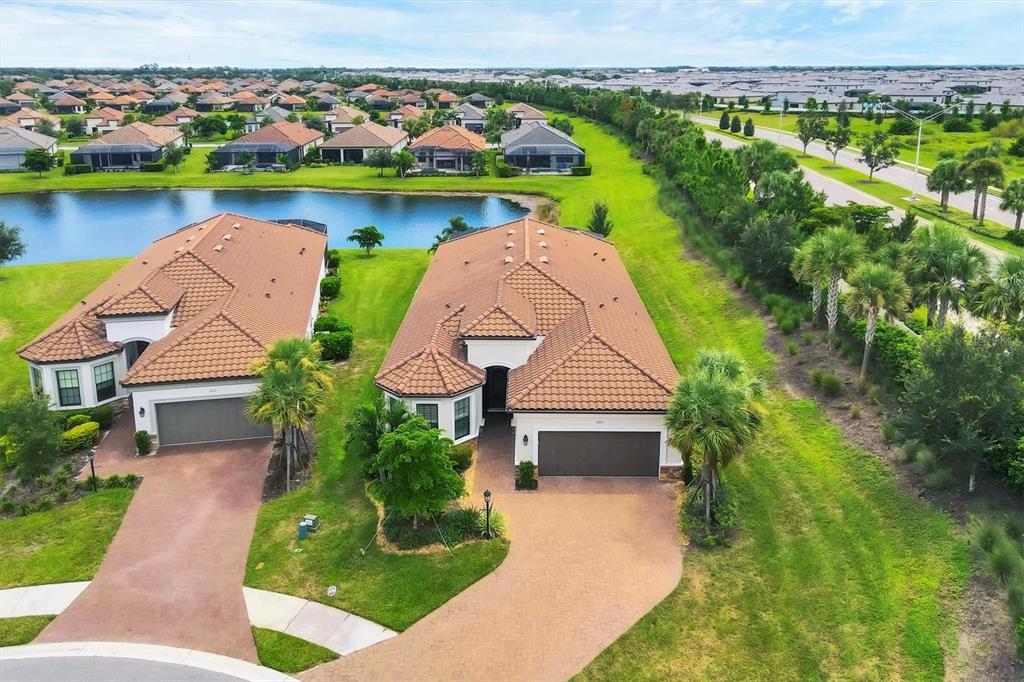 4735 Cassio Court Bradenton, FL 34211 - Photo 43 of 100 an aerial view of a house with a garden and lake view