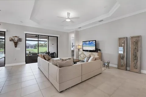 a living room with furniture and a view of bedroom