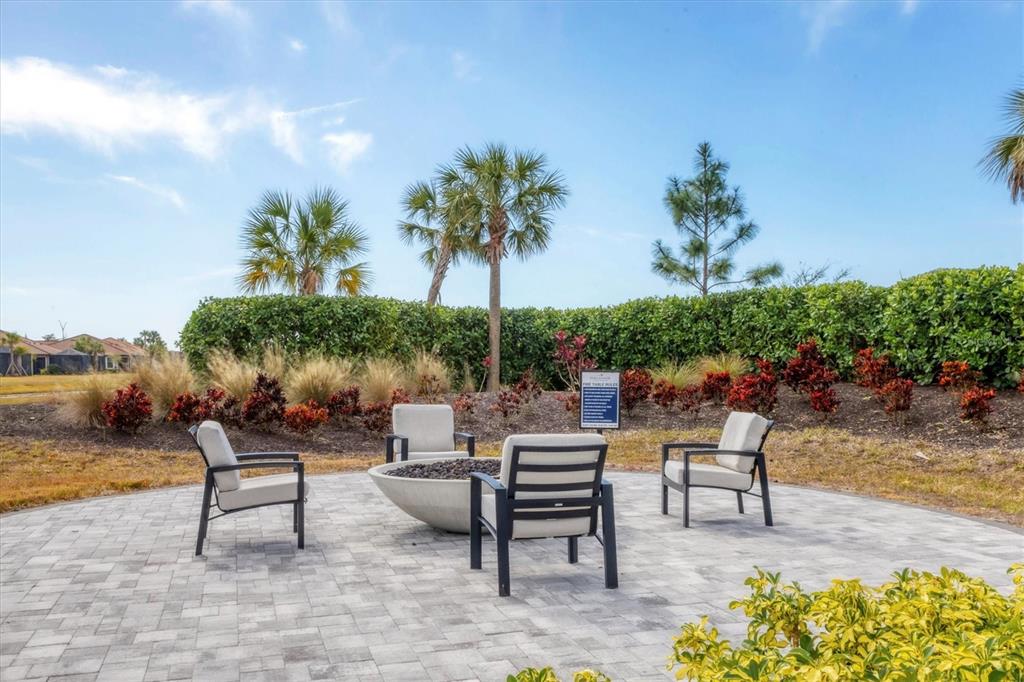 4735 Cassio Court Bradenton, FL 34211 - Photo 60 of 100 a swimming pool with outdoor seating and a potted plant