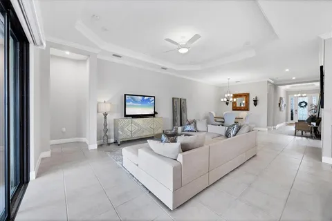 a large white kitchen with a large window a sink and stainless steel appliances