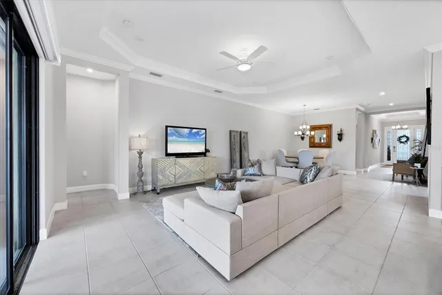 a large white kitchen with a large window a sink and stainless steel appliances