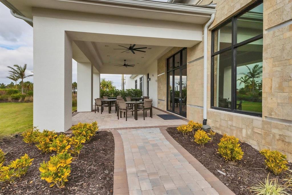 4735 Cassio Court Bradenton, FL 34211 - Photo 77 of 100 a view of a patio with table and chairs potted plants
