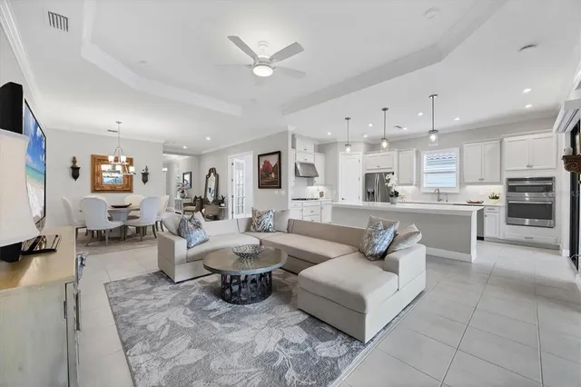 a dining room with furniture a chandelier and wooden floor