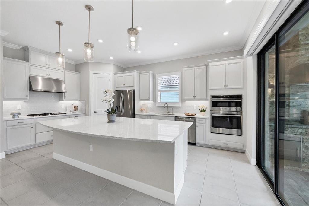 4735 Cassio Court Bradenton, FL 34211 - Photo 10 of 100 a large white kitchen with lots of counter space a sink appliances and cabinets