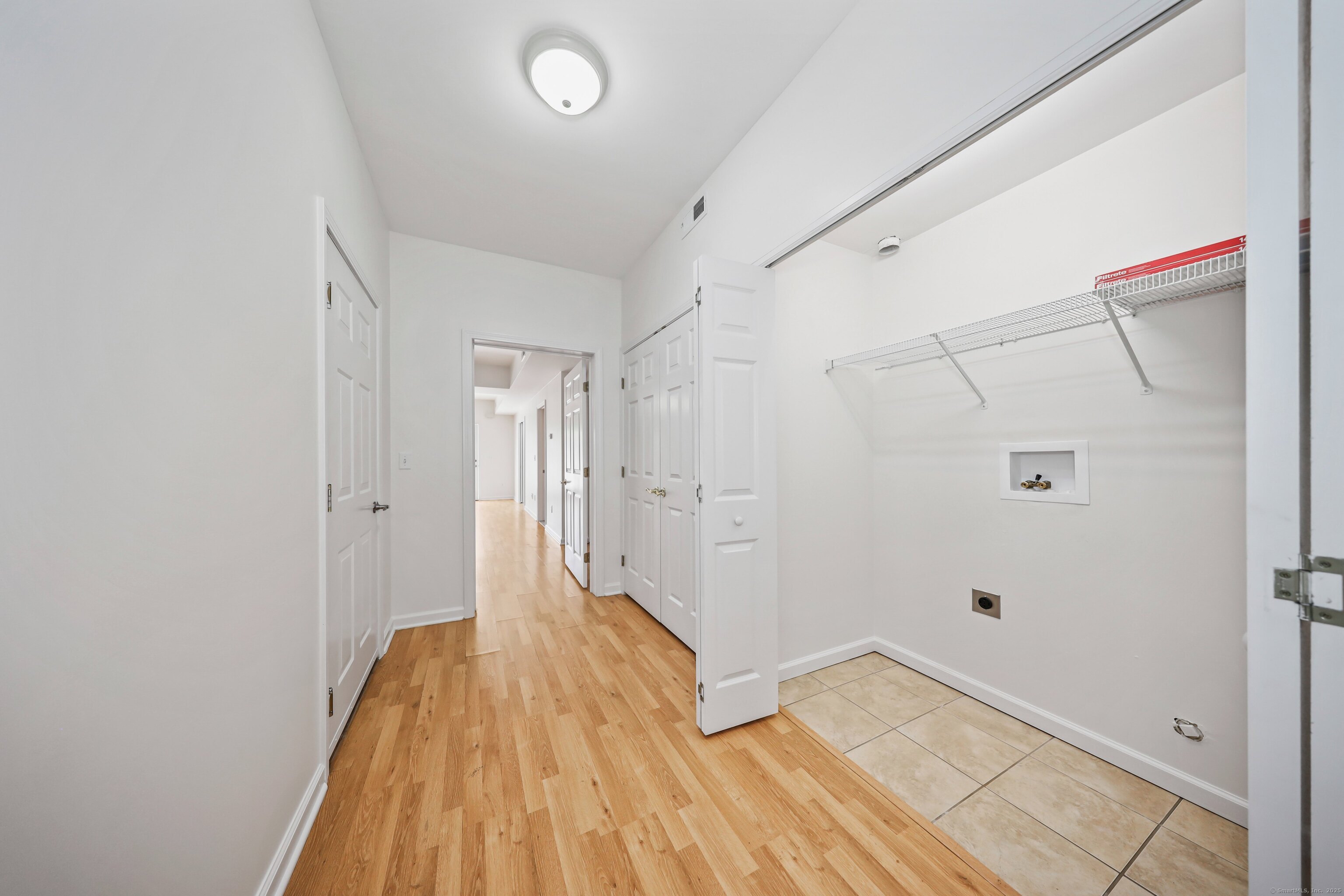 211 Pine Hill Boulevard, Unit 211 Plymouth, CT 06782 - Photo 21 of 35 a view of a hallway with wooden floor and a bathroom