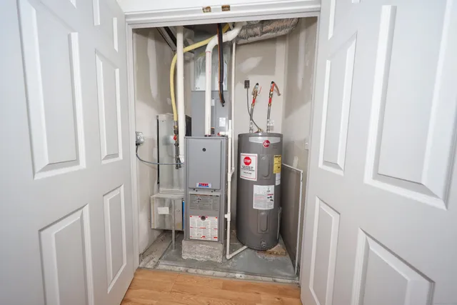 a view of a house with a small yard and potted plants