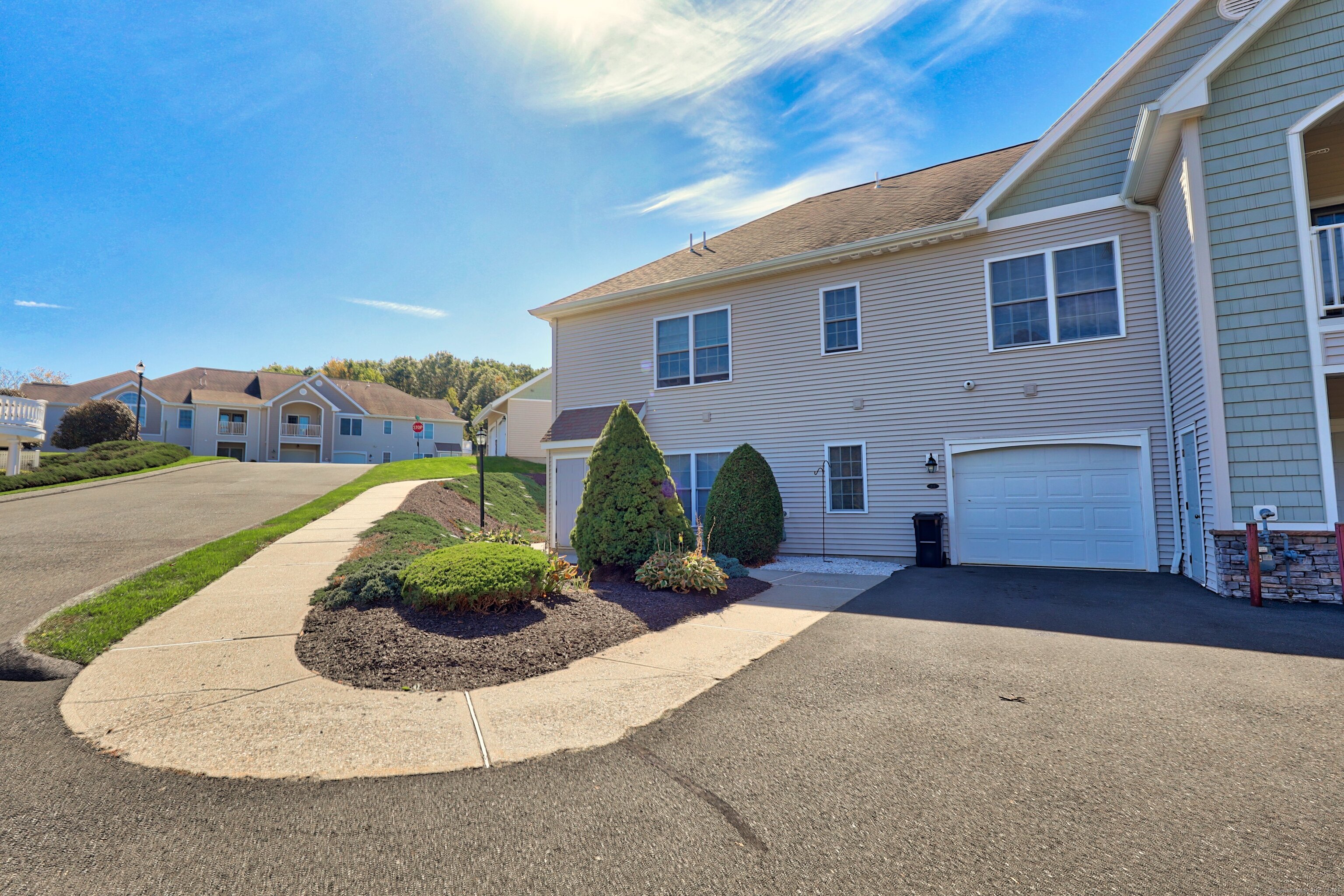 211 Pine Hill Boulevard, Unit 211 Plymouth, CT 06782 - Photo 25 of 35 a view of a house with a yard and garage