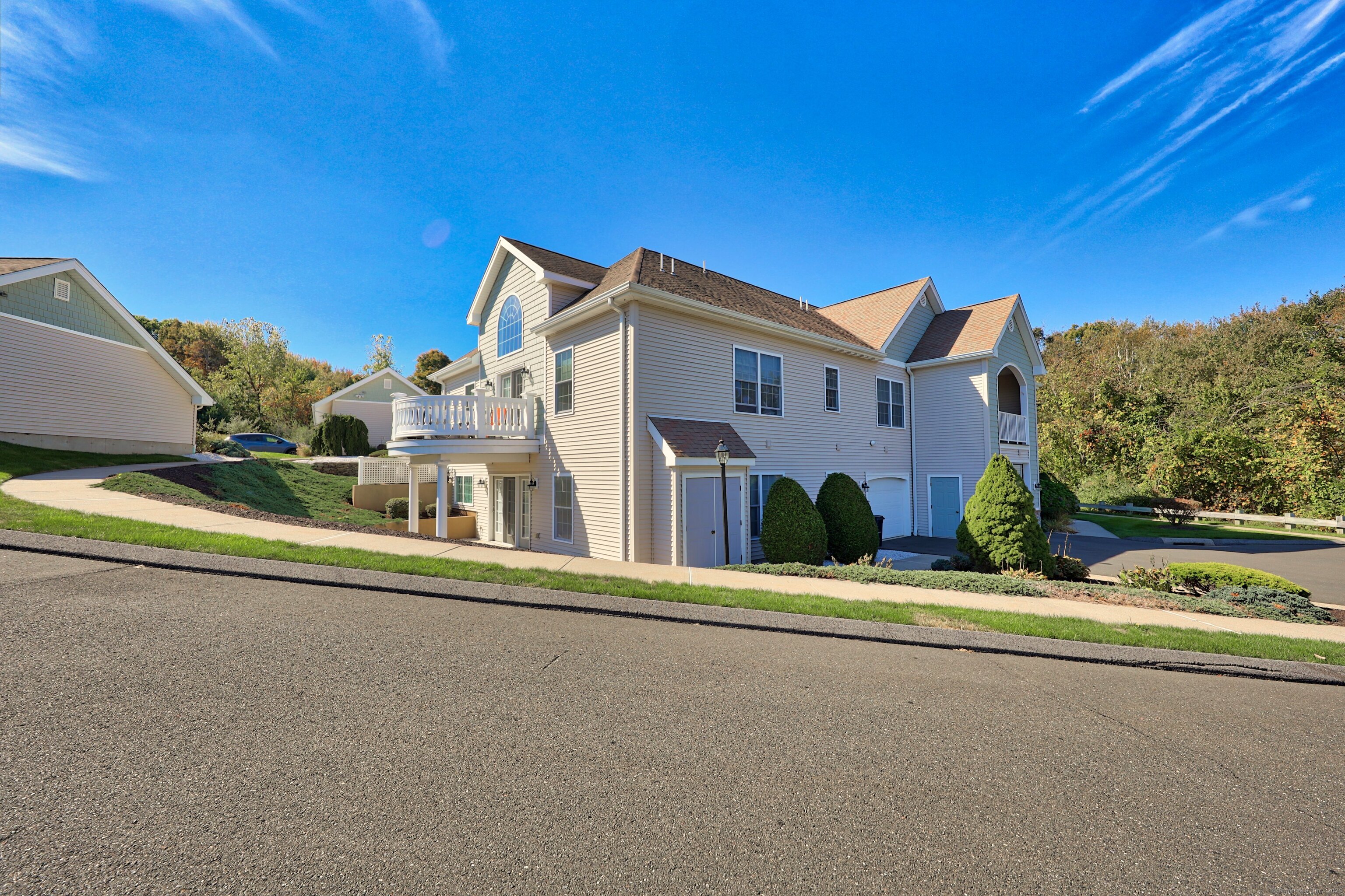 211 Pine Hill Boulevard, Unit 211 Plymouth, CT 06782 - Photo 27 of 35 a front view of a house with a yard and garage