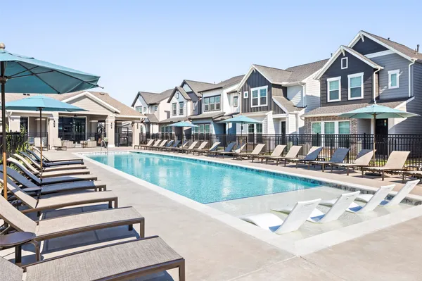 a view of a house with swimming pool and sitting area
