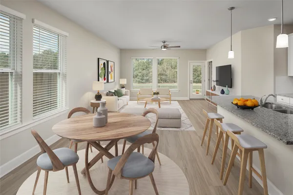 a view of a dining room with furniture and a large window