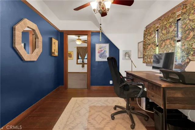 a view of a room with a window and a fan