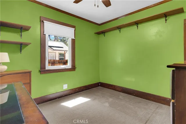 a white kitchen with a sink and white cabinets