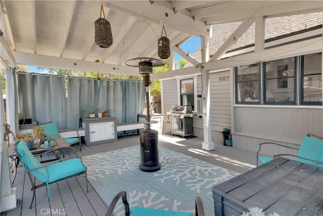 a view of a patio with a table chairs and wooden fence