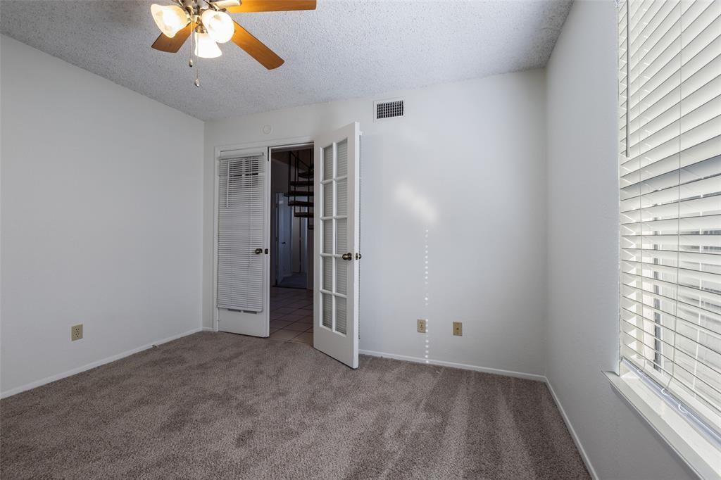 3506 Speedway, Unit 302 Austin, TX 78705 - Photo 11 of 27 Unfurnished bedroom with a textured ceiling, carpet, and a ceiling fan