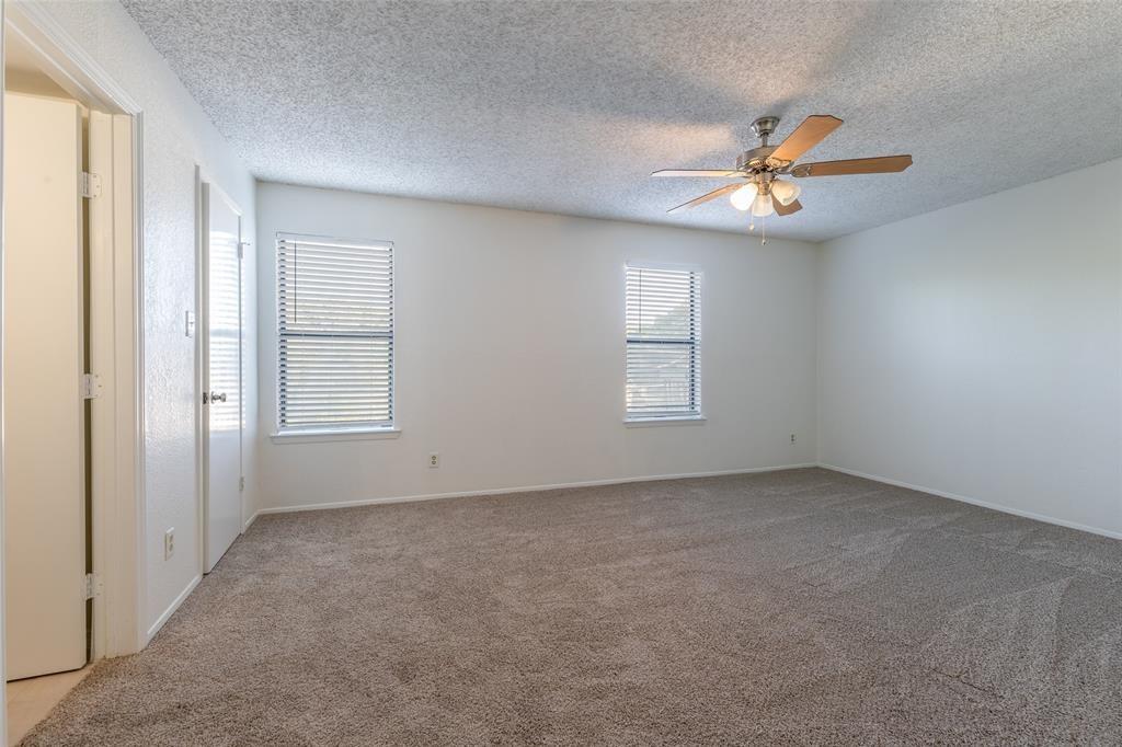 3506 Speedway, Unit 302 Austin, TX 78705 - Photo 12 of 27 Unfurnished room featuring light colored carpet, a ceiling fan, and a textured ceiling