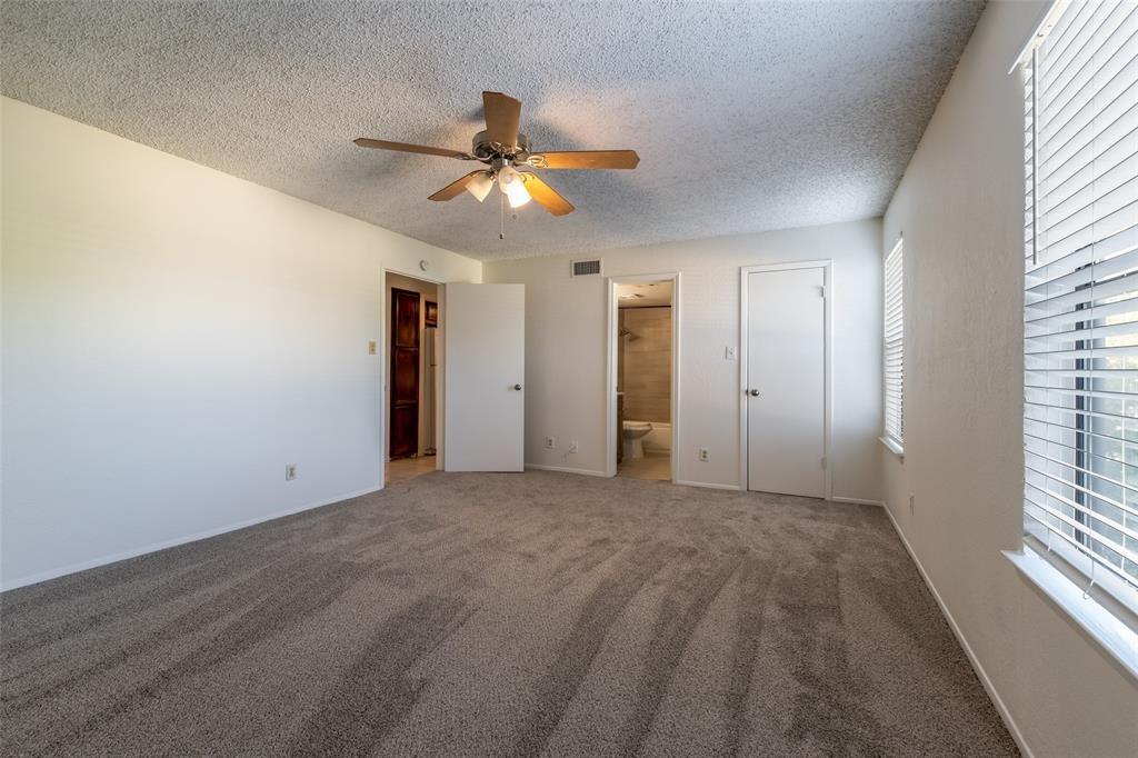 3506 Speedway, Unit 302 Austin, TX 78705 - Photo 14 of 27 Unfurnished bedroom featuring a textured ceiling, carpet, ceiling fan, and ensuite bathroom