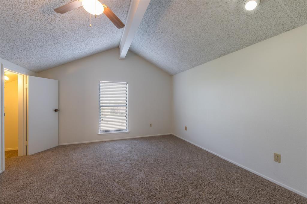 3506 Speedway, Unit 302 Austin, TX 78705 - Photo 16 of 27 Unfurnished room featuring a textured ceiling, carpet flooring, beam ceiling, and ceiling fan
