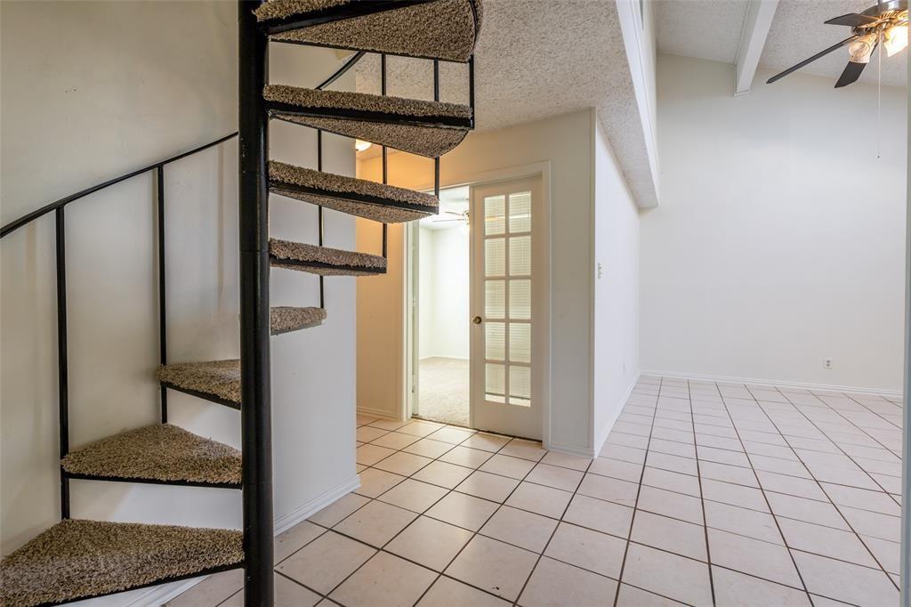3506 Speedway, Unit 302 Austin, TX 78705 - Photo 6 of 27 Stairway featuring ceiling fan, a textured ceiling, tile patterned floors, and beamed ceiling
