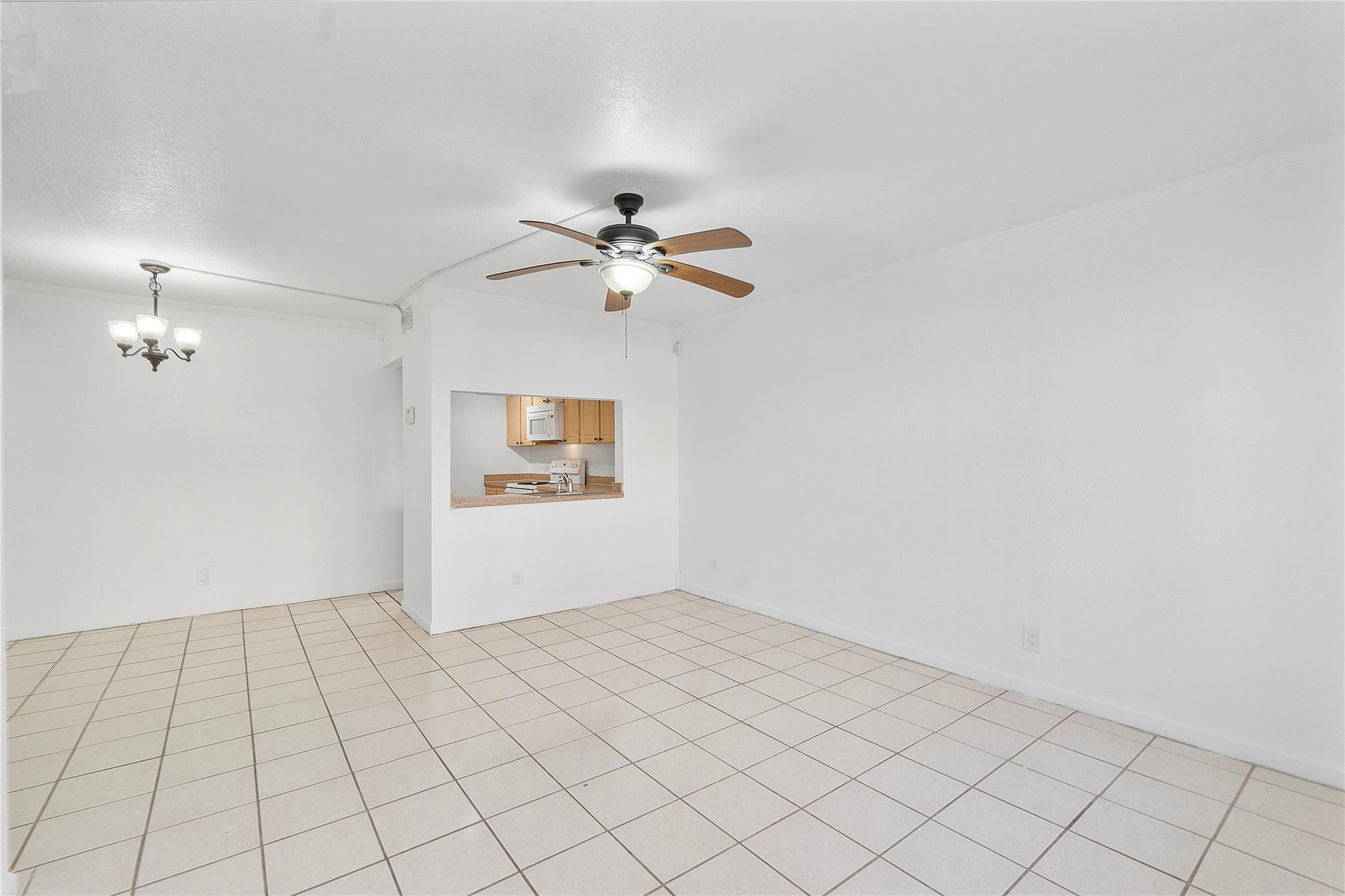 10054 Winding Lake Road, Unit 104 Sunrise, FL 33351 - Photo 2 of 13 an empty room with white walls and ceiling fan