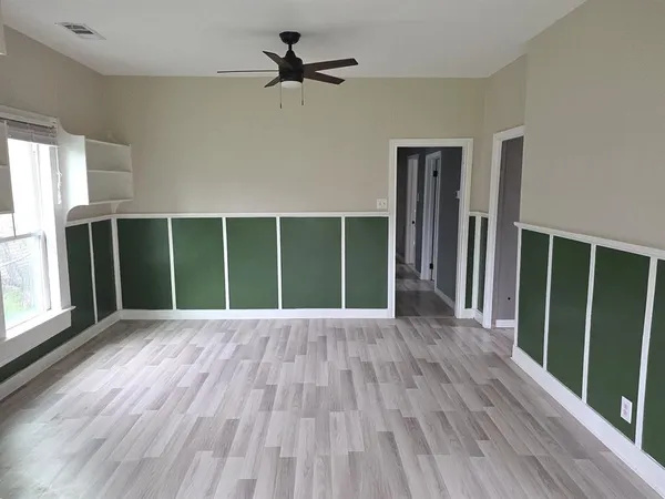 wooden floor in an empty room with a window
