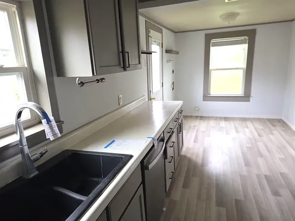 a view of a kitchen with wooden floor and staircase