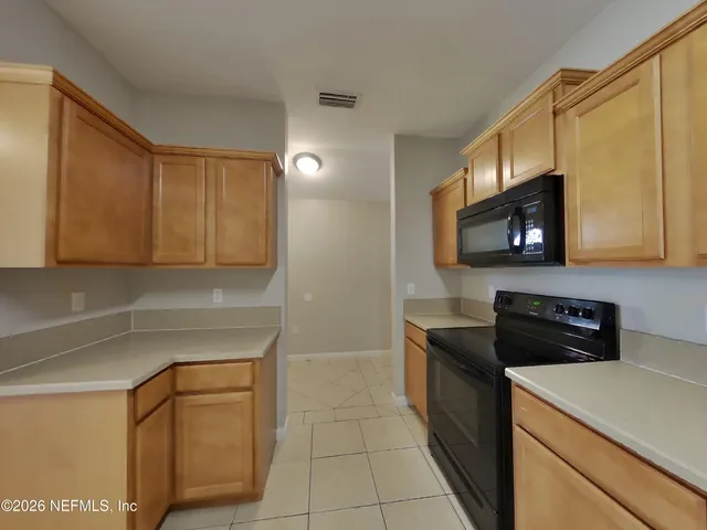 a kitchen with stainless steel appliances granite countertop a sink stove and microwave