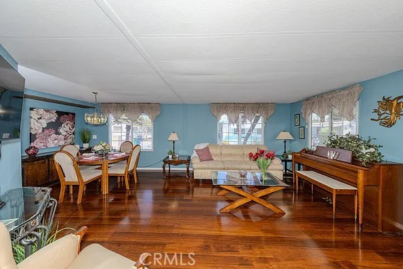 a living room with furniture a rug and white walls