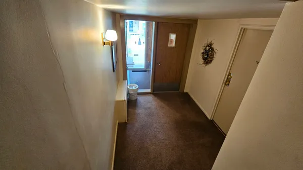 a view of a livingroom from a hallway