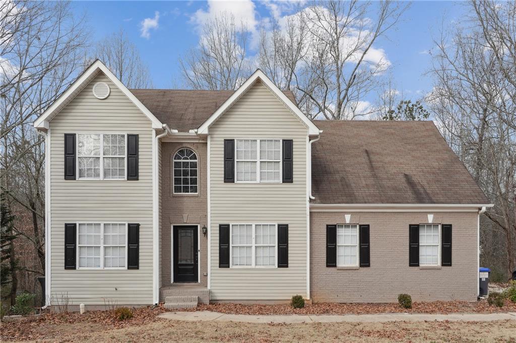 a front view of a house with trees