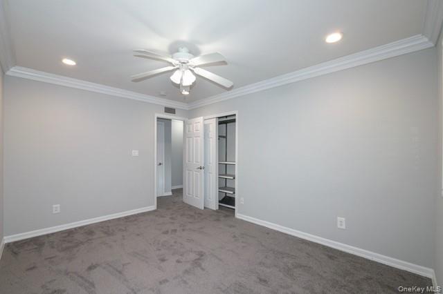 111 College Road, Unit 2F Selden, NY 11784 - Photo 10 of 11 an empty room with a ceiling fan and a window