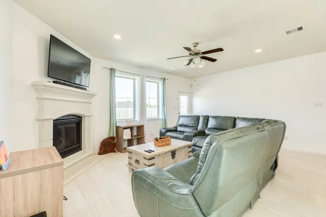 a living room with furniture fireplace and flat screen tv