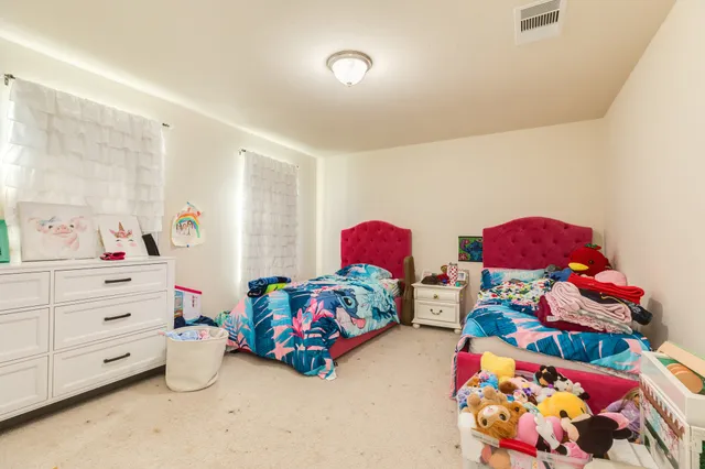 a bedroom with toys and dresser