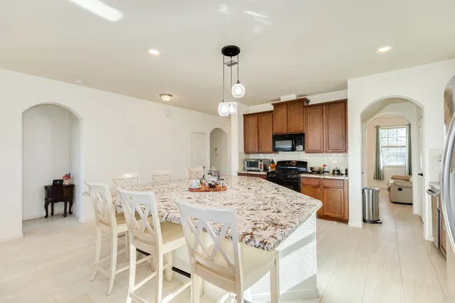 a large kitchen with a table and chairs