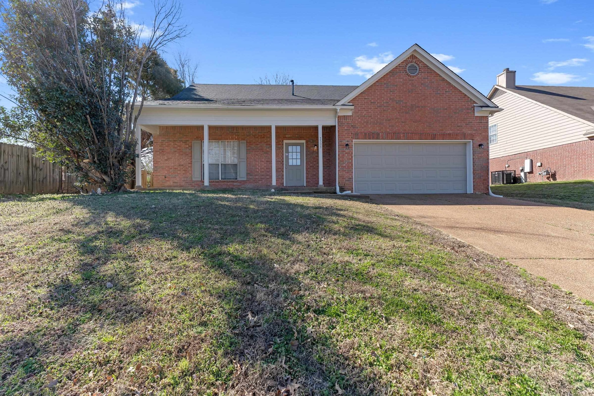 2593 Kate Bond Road Memphis, TN 38133 - Photo 1 of 33 a front view of a house with a yard and garage