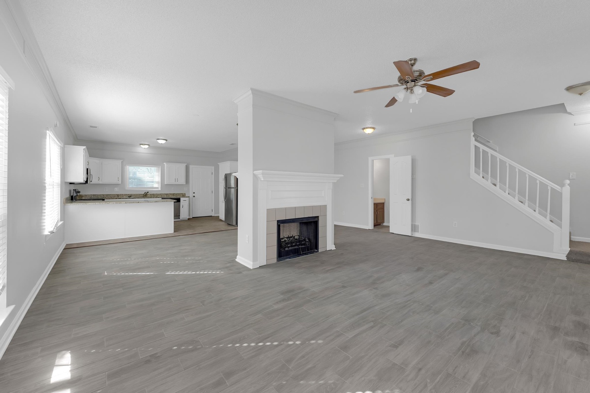 2593 Kate Bond Road Memphis, TN 38133 - Photo 29 of 33 a view of a livingroom with a fireplace a ceiling fan a fireplace and entryway