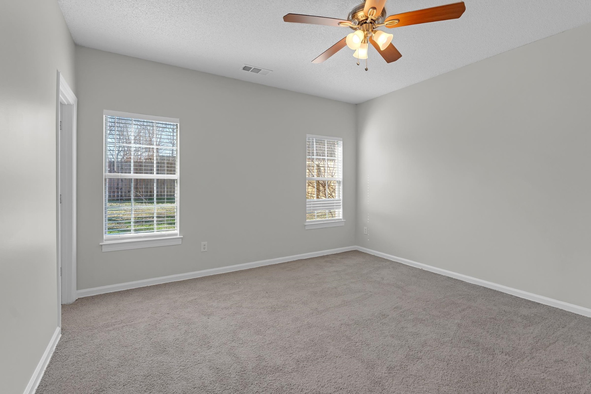 2593 Kate Bond Road Memphis, TN 38133 - Photo 6 of 33 an empty room with windows and fan