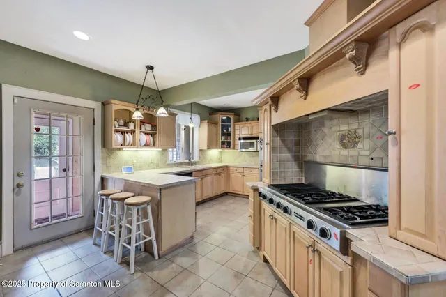 a kitchen with stainless steel appliances granite countertop a sink and cabinets