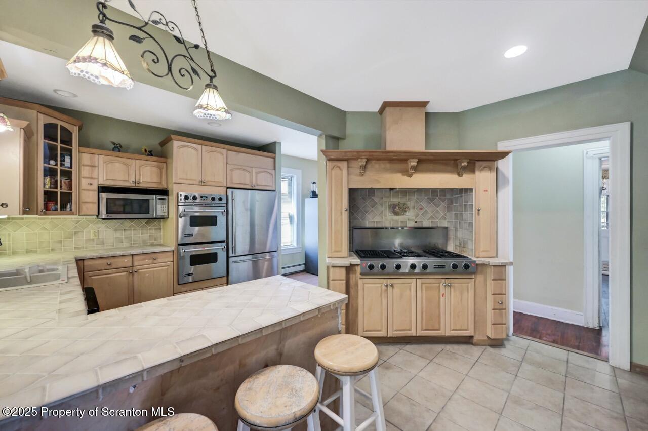 616-618 Harrison Avenue Scranton, PA 18510 - Photo 17 of 73 a kitchen with stainless steel appliances a stove a microwave and a counter top space