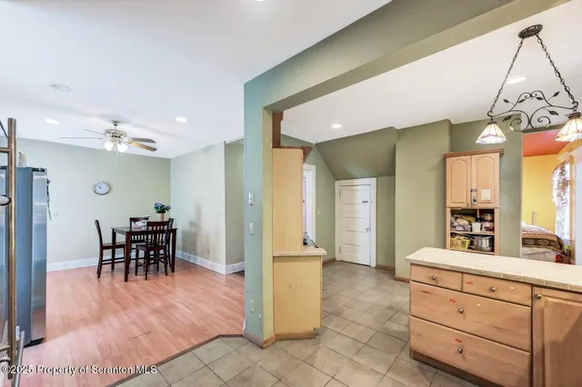 a living room with furniture or chandelier and a wooden floor